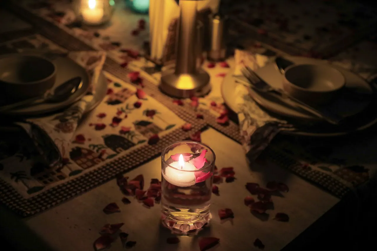 Candlelit dinner table with rose petals at Cafe DO NTHNG in Manali