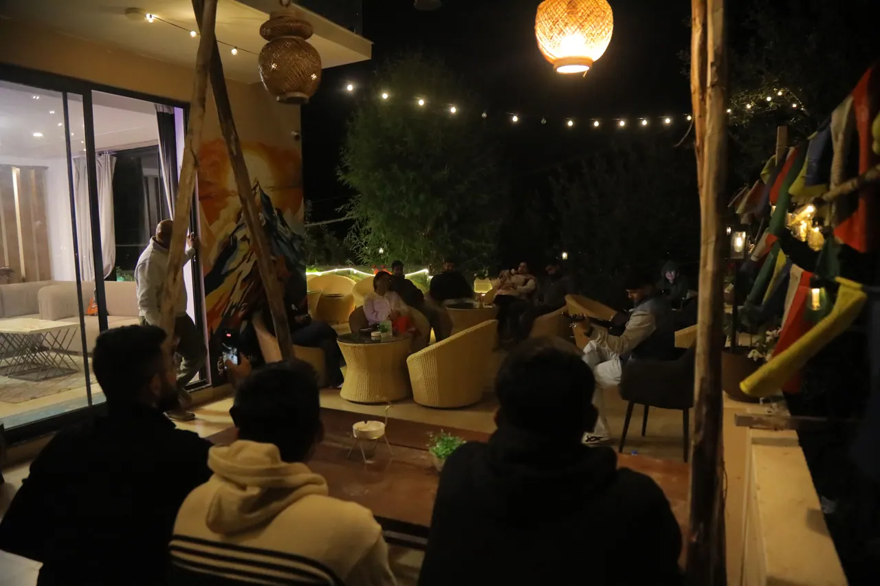 Mountain terrace at Bar and Cafe Do NTHNG in Manali illuminated with fairy lights at night